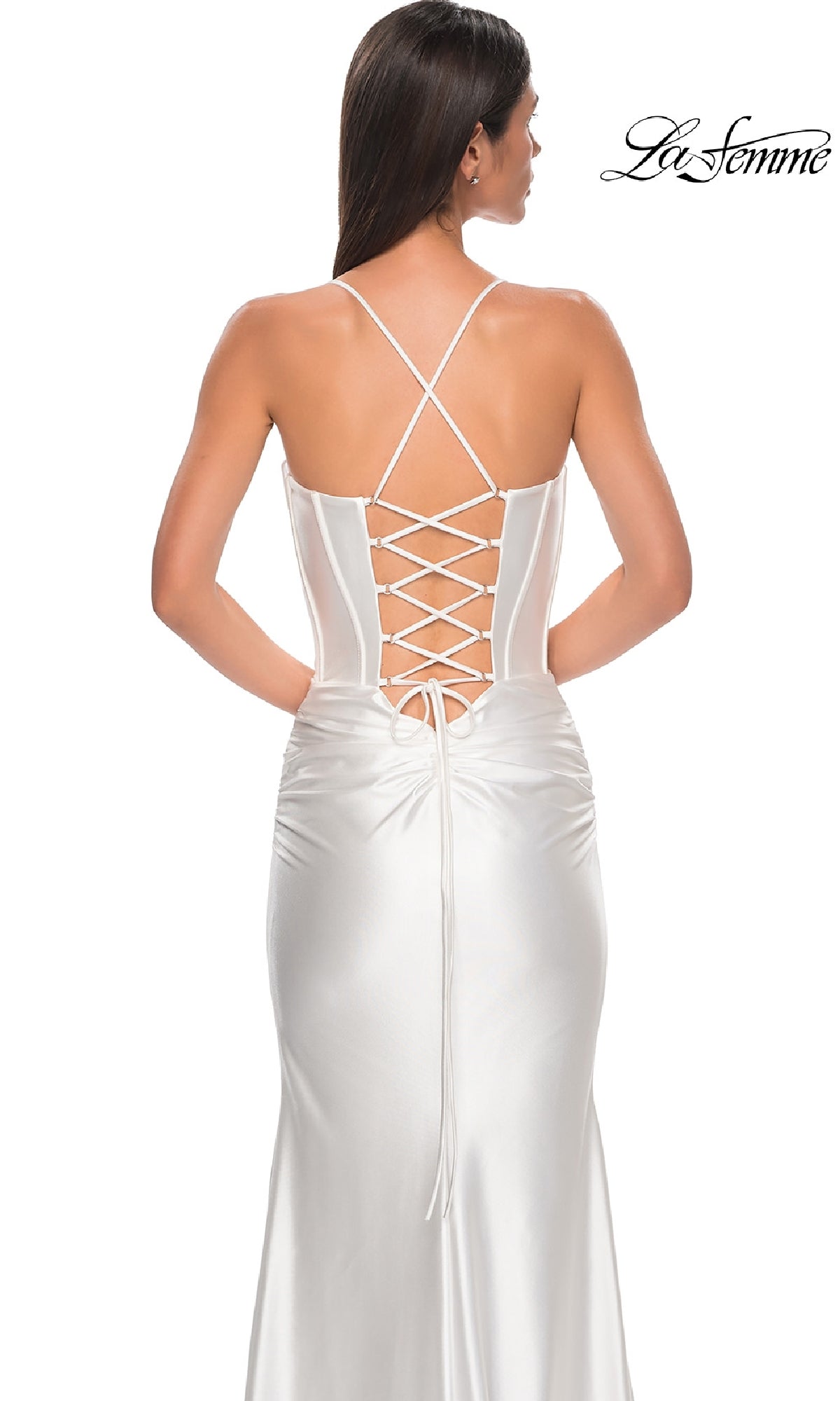 A woman is shown from behind wearing the Lace-Up Long Satin Prom Dress: La Femme 32683, featuring a white satin finish, corset-style bodice, lace-up back, and crisscross straps. The